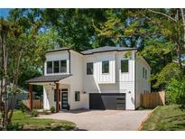 Charming modern two-story home with white siding, black trim, and a beautifully paved driveway at 156 Martha Ne Ave, Atlanta, GA 30317