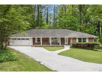 Charming brick home with a well-manicured lawn and inviting driveway at 2429 Sherbrooke Ne Ct, Atlanta, GA 30345