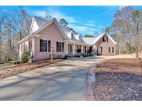 A charming brick home features a long driveway and well-manicured landscaping at 239 Trail Nw Rd, Marietta, GA 30064