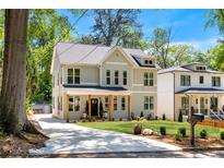 Charming two-story home with a well-manicured lawn and inviting front porch at 2553 Creekwood Ter, Decatur, GA 30030