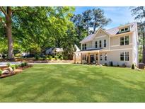 Charming two-story home featuring a lush green lawn and mature trees in a desirable neighborhood at 2553 Creekwood Ter, Decatur, GA 30030