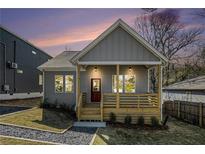 Charming home with a welcoming porch and landscaped front yard offers great curb appeal at 102 Dahlia Sw Ave, Atlanta, GA 30314