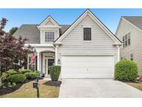Charming two-story home featuring a two-car garage and manicured front yard at 1620 Diplomat Dr, Cumming, GA 30041