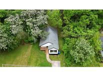 An aerial view of a charming home surrounded by lush trees and greenery at 1111 Osborne Sw St, Atlanta, GA 30310