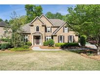 Beautiful two-story brick home with a stone facade and manicured landscaping at 1459 Hickory Branch Nw Trl, Kennesaw, GA 30152