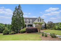 Charming home featuring a well-manicured lawn and lush landscaping at 639 Puckett Se Rd, Emerson, GA 30137