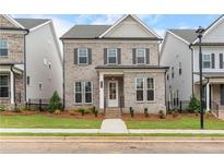 Charming two-story brick home with a well-manicured lawn and classic architectural details at 146 Birch Tree Way, Cumming, GA 30040