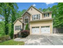 Charming two-story home with stone accents, a two-car garage, and well-maintained landscaping at 160 Wentworth Dr, Canton, GA 30114