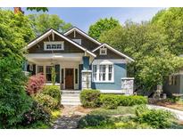 Charming craftsman home with blue facade, stone accents, and lush landscaping at 342 5Th Ne St, Atlanta, GA 30308