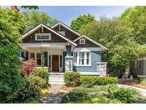 Charming home exterior featuring a well-manicured lawn and a welcoming front porch at 342 5Th Ne St, Atlanta, GA 30308