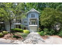 Charming townhome with gray siding, inviting front yard, and attached garage at 1440 Hillpine Ln, Atlanta, GA 30306