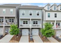 Charming three-story townhomes with stone accents, attached garages, and private balconies at 2110 Prichard Park Dr, Kennesaw, GA 30144
