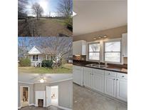 Bright kitchen featuring white cabinets, wood countertops and double sinks at 2651 Old Lost Mountain Rd, Powder Springs, GA 30127