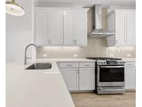 Bright kitchen featuring white cabinets, stainless steel appliances, and granite countertops at 2872 Evanshire Ave # 116, Duluth, GA 30096