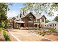 Stunning Tudor-style home featuring brick and stucco, a spacious driveway, and meticulously landscaped grounds at 1585 S Ponce De Leon Ne Ave # 20, Atlanta, GA 30307