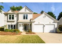 Charming two-story home with stucco exterior, well-manicured lawn, and a two-car garage at 3545 River Summit Trl, Duluth, GA 30097