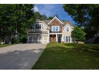 Charming two-story home with stone accents, inviting entrance, and well-manicured lawn at 36 Evergreen Way, Dallas, GA 30157
