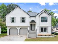 Charming two-story home featuring a two-car garage, well-maintained lawn, and inviting front entrance at 4258 Anderson Ridge Way, Austell, GA 30106