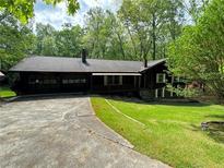 Charming single-story home featuring a convenient two-car garage and well-maintained lawn at 880 Havenridge Dr, Conyers, GA 30094