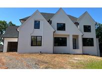 A charming, newly constructed two-story home featuring a white brick facade, black framed windows and an attached garage at 2856 Octavia Cir, Marietta, GA 30062