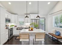 Modern kitchen with stainless steel appliances, white cabinets, and a kitchen island with bar stool seating at 198 Clay Se St # G, Atlanta, GA 30317