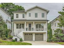 Stunning two-story home featuring a charming front porch and a two-car garage at 1059 Antioch Dr, Brookhaven, GA 30319
