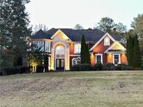 Stunning brick home with manicured lawn and elegant architectural details at 20 Rosemont Pkwy, Covington, GA 30016