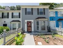 Charming townhome featuring a well-manicured front yard and traditional architectural details at 5607 Stonington Trace Pkwy, Stone Mountain, GA 30087
