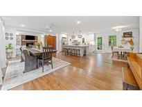 Open-concept living and kitchen area with hardwood floors and abundant natural light at 751 Upper Burris Rd, Canton, GA 30114