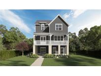 Charming two-story home with a welcoming front porch, detailed trim, and manicured lawn at 1432 Fairmont Ave, Atlanta, GA 30318