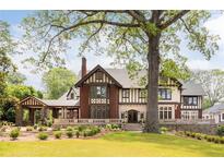 Beautiful Tudor-style home with brick and stucco exterior, mature landscaping, and a porte-cochère at 1585 S Ponce De Leon Ne Ave # 19, Atlanta, GA 30307