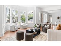 Bright and airy living room with large bay windows and neutral-toned furniture creating a cozy and inviting space at 1585 S Ponce De Leon Ne Ave # 19, Atlanta, GA 30307