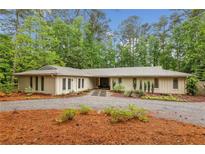 Charming ranch-style home with well-manicured landscaping and a circular driveway at 11540 Northgate Way, Roswell, GA 30075