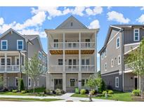 Charming new construction home with multiple porches and manicured landscaping at 1417 Coretta Scott Bnd, Atlanta, GA 30318