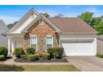 Charming home featuring stone accents, manicured landscaping, and a two-car garage at 3321 Hampreston Nw Way, Kennesaw, GA 30144
