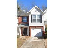 Charming two-story townhouse features a brick and white facade, black shutters, and attached garage at 3777 Harvest Dr, Decatur, GA 30034