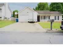 Charming single-Gathering home with a well-maintained front yard and a long driveway at 2568 Morning Glory Pl, Lawrenceville, GA 30044