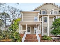 Charming two-story home featuring a welcoming front porch with classic columns and a brick stairway at 1409 Oakridge Cir, Decatur, GA 30033