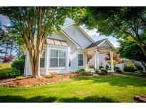 Charming one-story home with well-manicured lawn, lush trees, and a welcoming covered porch at 2752 Nautical Way, Villa Rica, GA 30180