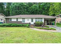 Charming single-story home with brick accents, a well-manicured lawn, and a cozy carport at 2882 Concord Dr, Decatur, GA 30033
