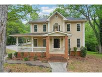 Charming two-story home featuring a welcoming front porch and traditional architectural details at 2650 Wendell Creek Ln, Snellville, GA 30039