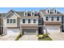 Charming townhomes with brick and siding exteriors, garages, and well-maintained lawns at 120 Maple Creek Way, Woodstock, GA 30188