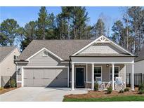 Charming single-story home featuring a covered front porch, gray siding, and an attached two-car garage at 1307 Cedarcrest Blvd, Acworth, GA 30101