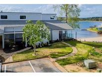 Waterfront condo with a sandy beach area and a well-maintained lawn at 277 Clearview Ct, Villa Rica, GA 30180