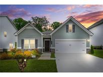 Charming single-story home with gray siding, a two-car garage, and a well-manicured front yard at 9010 Jim Purcell Dr, Covington, GA 30014