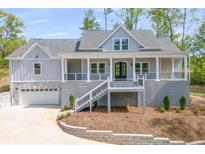 Charming two-story home featuring a welcoming front porch, gray siding, and an attached two car garage at 2841 Bettis Ct, Marietta, GA 30066