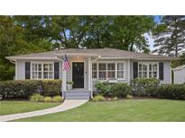 Charming single-story home with gray siding, black shutters, manicured lawn, and front garden at 1788 Beacon Hill Ne Blvd, Atlanta, GA 30329