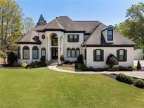 Stunning two-story home boasts meticulous landscaping, arched windows, and a grand entrance at 1015 Bedford Gardens Dr, Alpharetta, GA 30022
