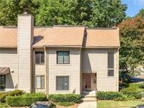 Charming two-story townhouse featuring a well-maintained lawn and a welcoming front entrance at 3500 Stonewall Pl, Atlanta, GA 30339