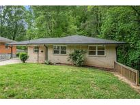Charming bungalow with a lush green front yard and mature trees in a desirable neighborhood at 446 Waterford Nw Rd, Atlanta, GA 30318